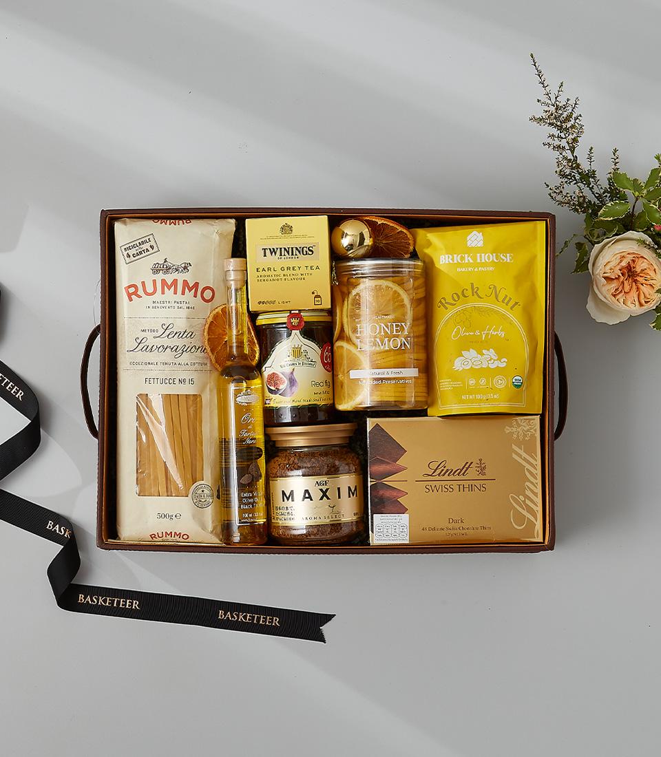 Luxury gourmet gift basket with pasta, olive oil, fig jam, Earl Grey tea and Swiss chocolate for New Year gifting
