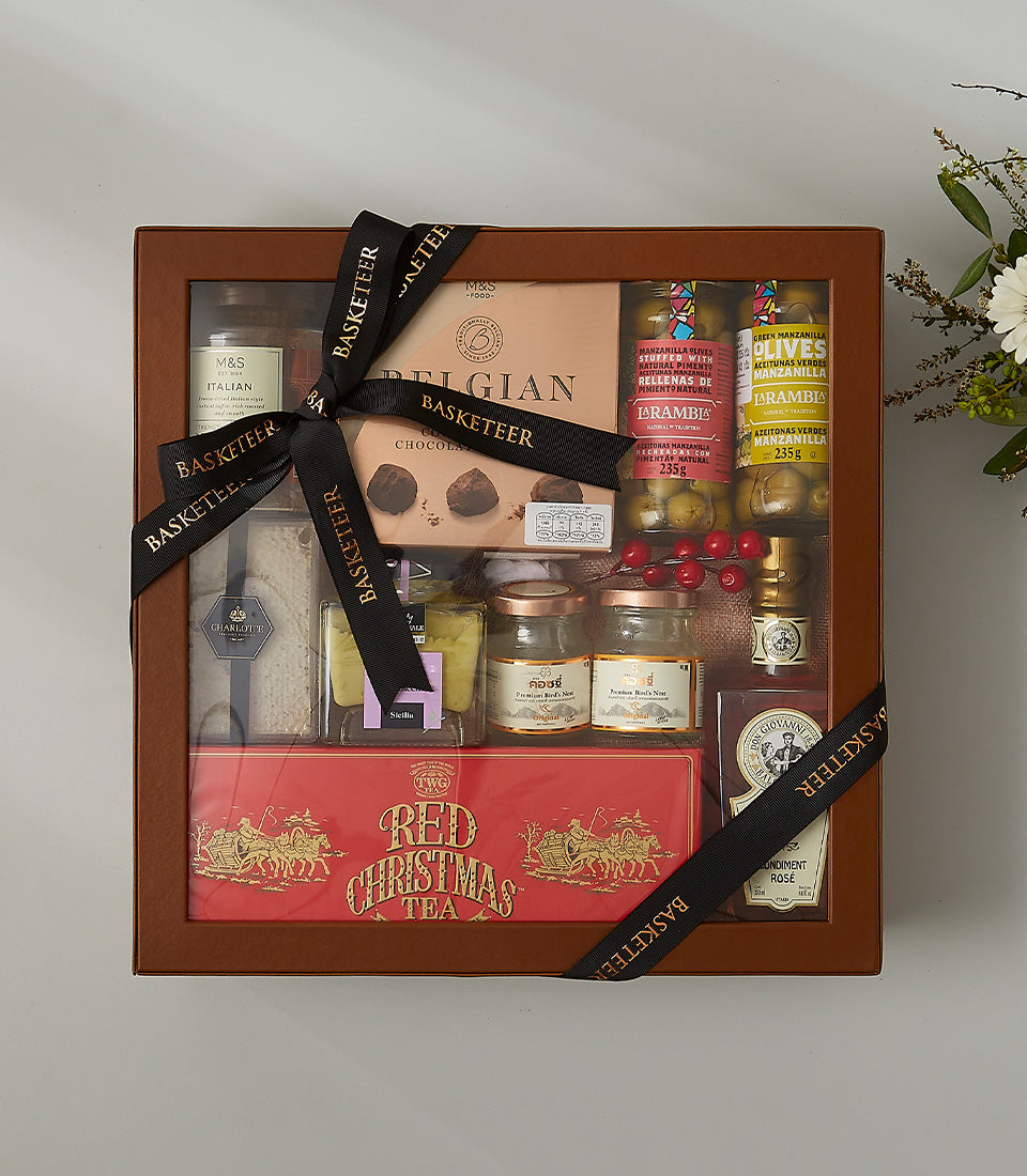 Luxury gourmet gift box with Italian delicacies, Belgian chocolates, premium bird's nest, olives, and festive tea in brown
