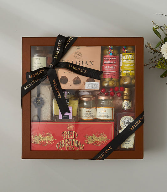 Luxury gourmet gift box with Italian delicacies, Belgian chocolates, premium bird's nest, olives, and festive tea in brown