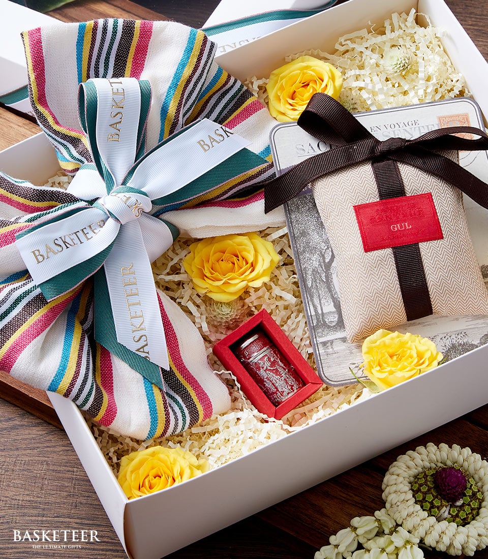Songkran gift set with incense, yellow roses, and traditional Thai floral garland in white presentation box