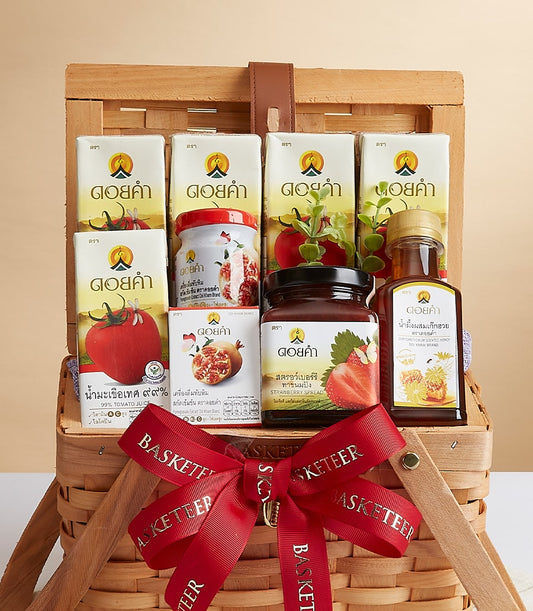 Premium Doi Kham wellness gift basket with organic tomato juice, honey, and fruit preserves in woven wood with red ribbon