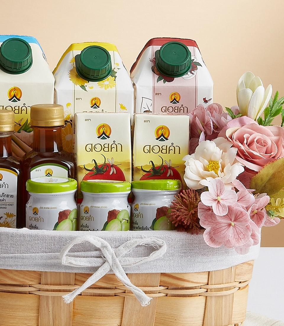 Woven wood gift basket with premium Doi Kham health and wellness products, honey bottles, and pink artificial flowers