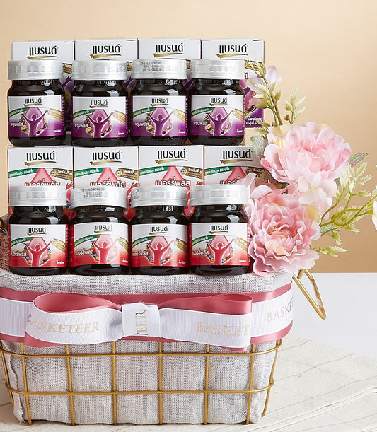 Berry Plus and Prune Plus bottled beverage gift basket with gold wire basket and pink-white ribbon bow