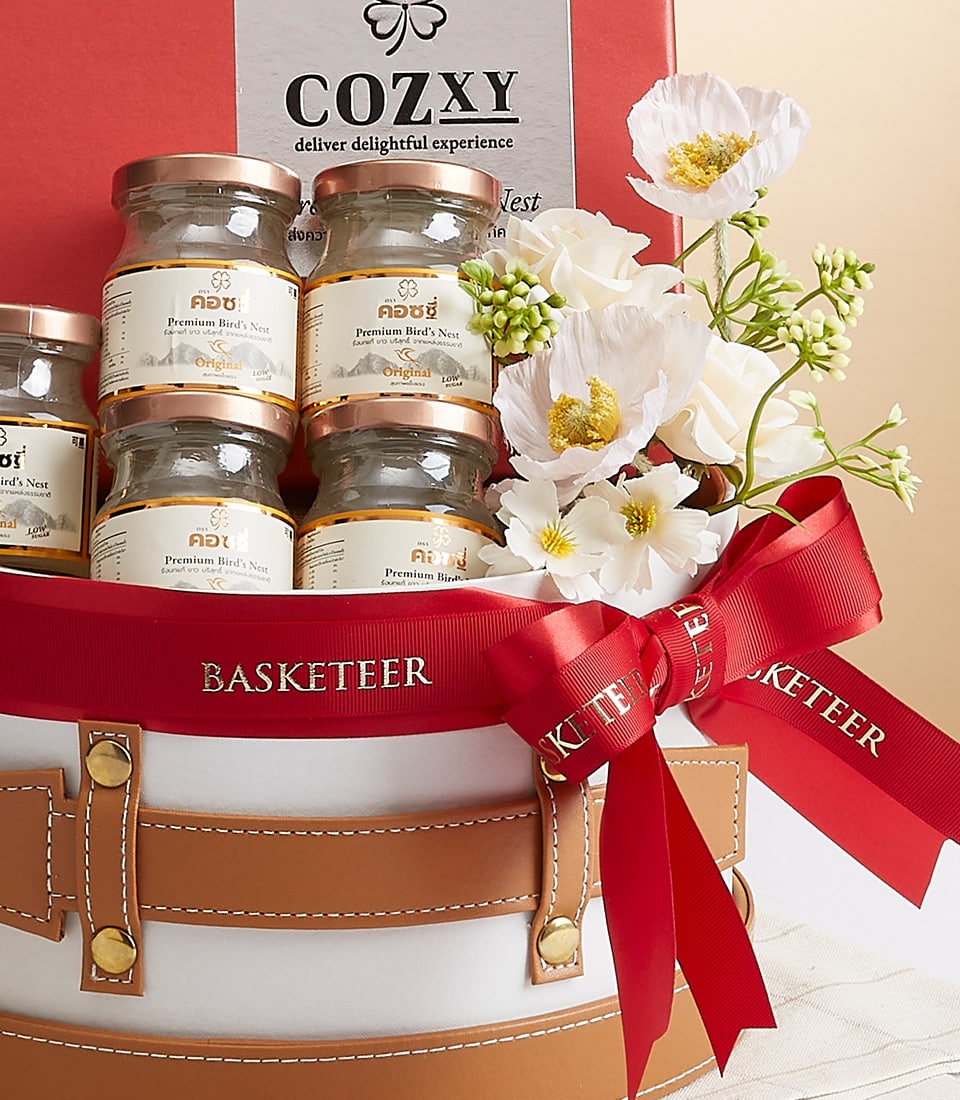 Premium bird's nest essence gift basket with six rose gold jars, white leather case, and red ribbon bow