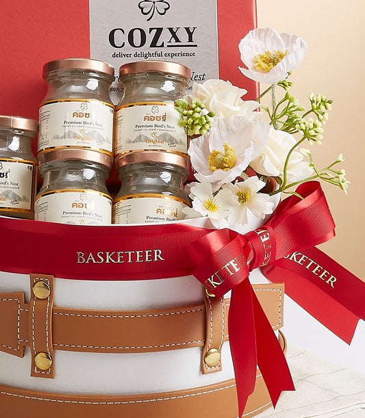 Premium bird's nest essence gift basket with six rose gold jars, white leather case, and red ribbon bow