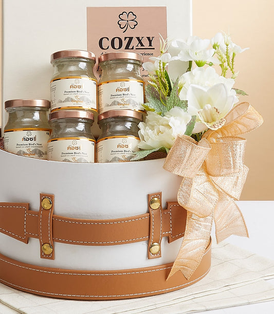 Premium bird's nest delicacies in luxury white gift box with gold accents and white orchids