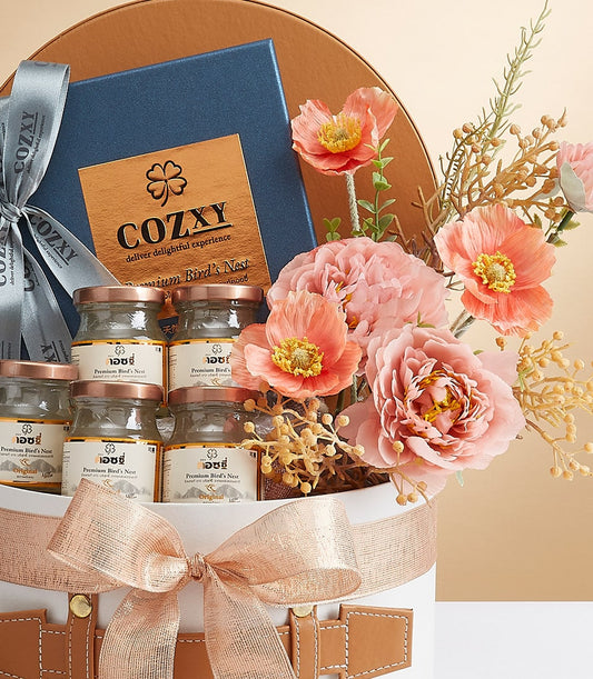 Premium bird's nest gift box with six glass jars, rose gold ribbon, leather strap, and peach silk flowers