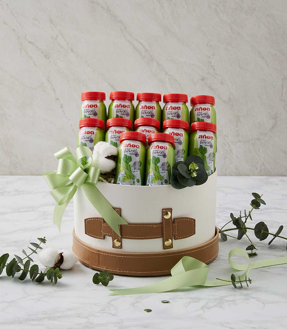 Premium Scotch celery drink gift box with twelve light green bottles, white suitcase-style case, and botanical accents