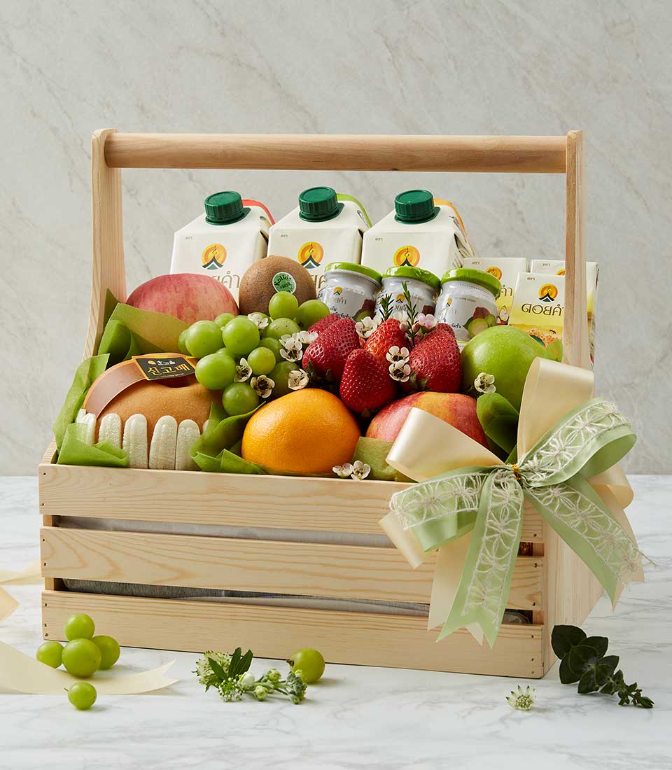 Fresh fruit and Doi Kham juice gift basket in wooden crate with apples, grapes, and strawberries for get well recovery