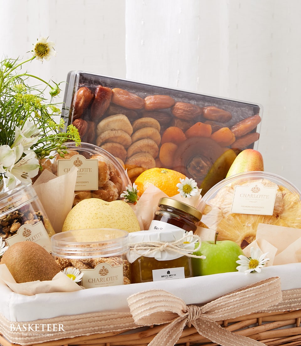 Woven wicker get well fruit basket with dried dates, figs, apricots, fresh kiwi, pear, apple, citrus, Charlotte baked goods,