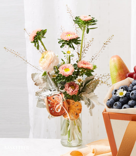 Premium get well fruit and flower combo with fresh berries, pear, and pastel asters in glass vase