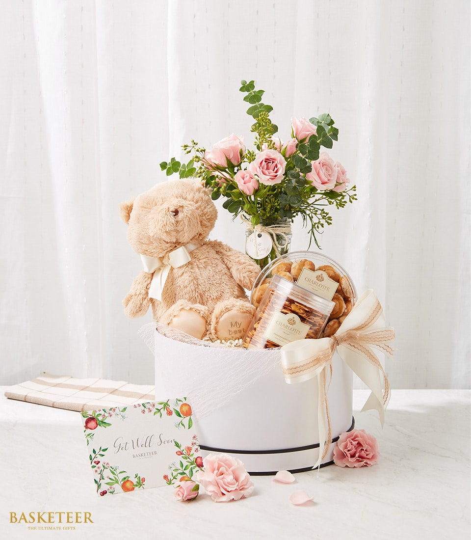 Cream and white gift basket with teddy bear, pink roses, and Charlotte Bakery cookies for get well wishes