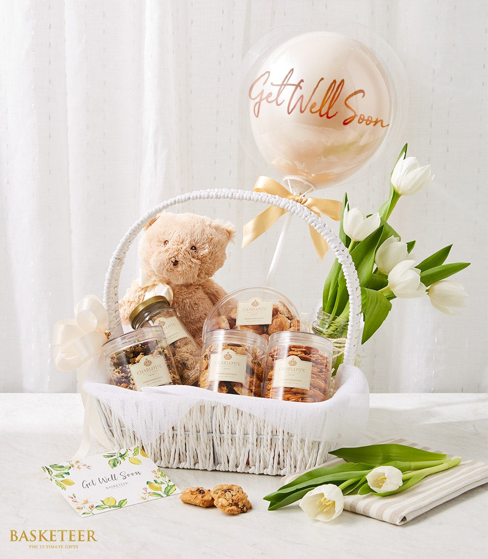 Cuddly Comfort get well gift basket with teddy bear, Charlotte cookies, white tulips and rose gold balloon