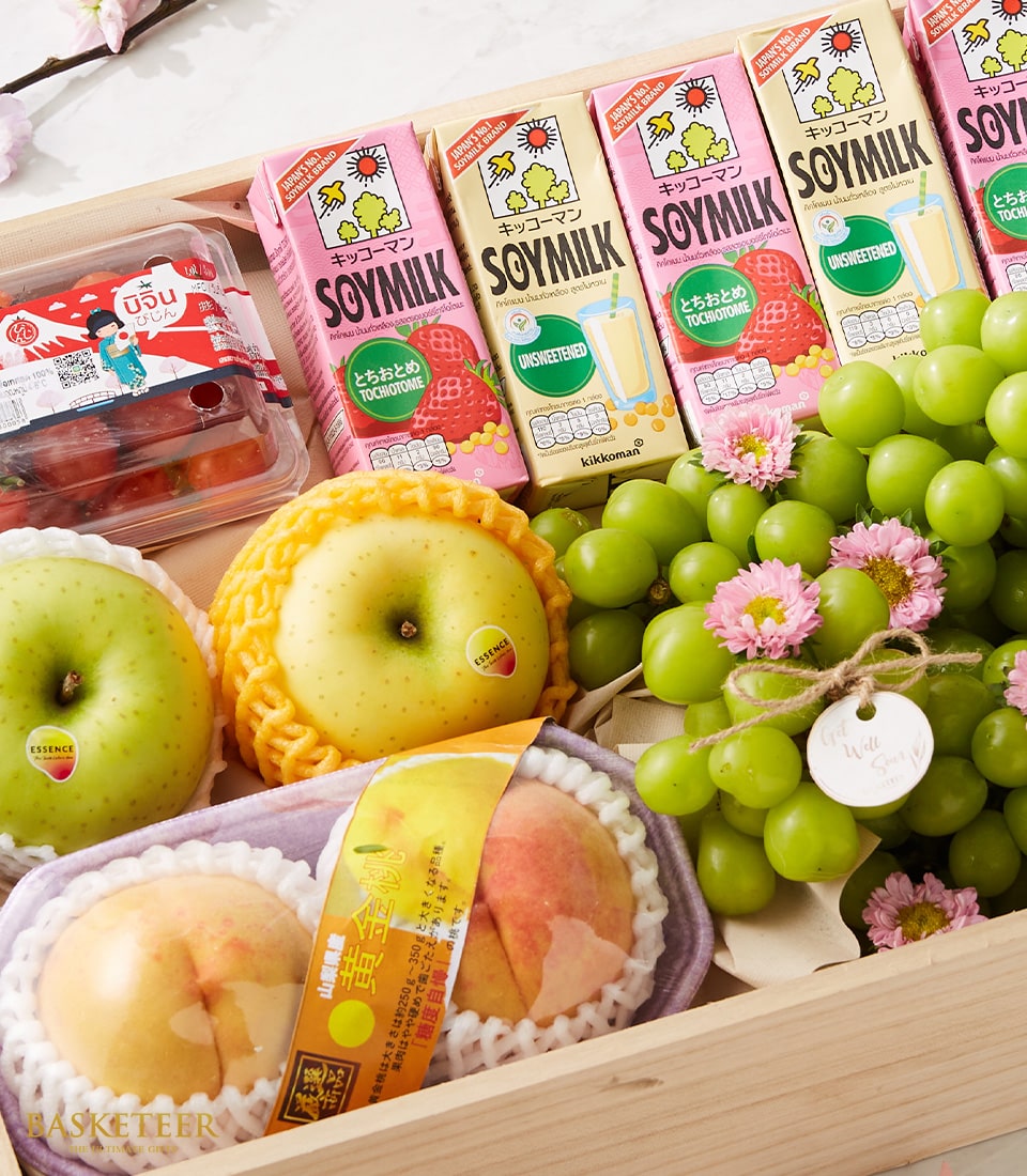 Premium fruit and gourmet gift box with fresh grapes, apples, peaches, soymilk, and cherry tomatoes in wooden presentation
