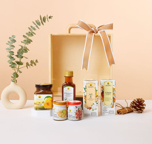 Premium wellness gift collection with eucalyptus, gourmet preserves, honey, and natural botanicals in wooden crate
