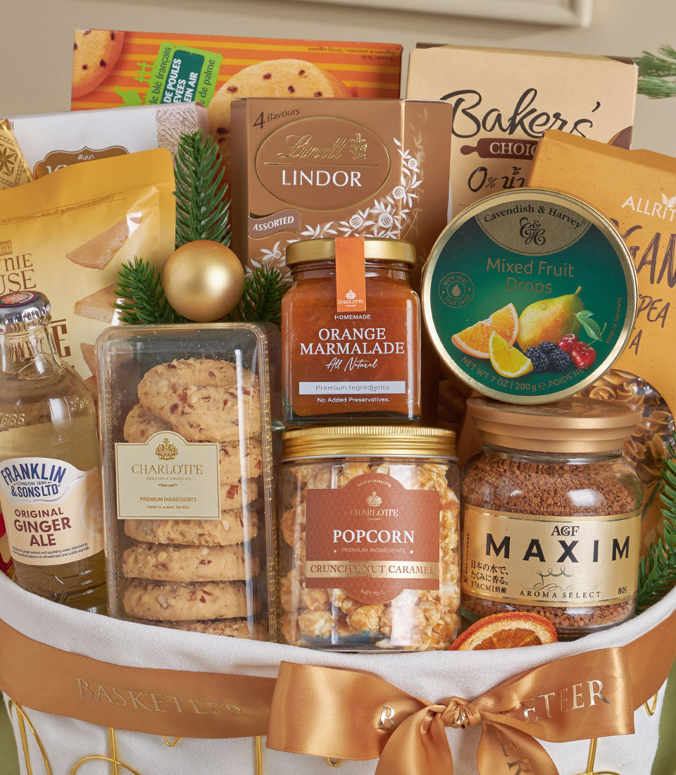 Golden Delight luxury gourmet gift basket with cookies, marmalade, caramel popcorn, coffee, and chocolates, tied with gold