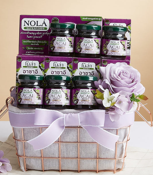 Rose gold wire gift basket with NOLA Acai Berry superfoods, purple ribbon bow, and artificial florals
