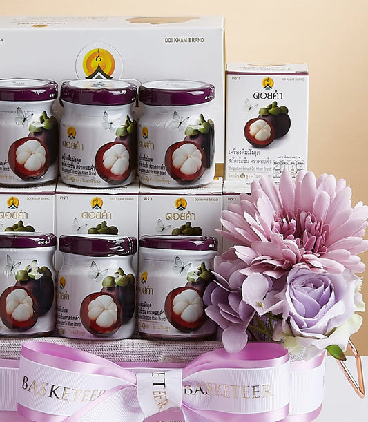 Premium pomegranate extract wellness gift basket with artisan jars, decorative flowers and ribbon bow