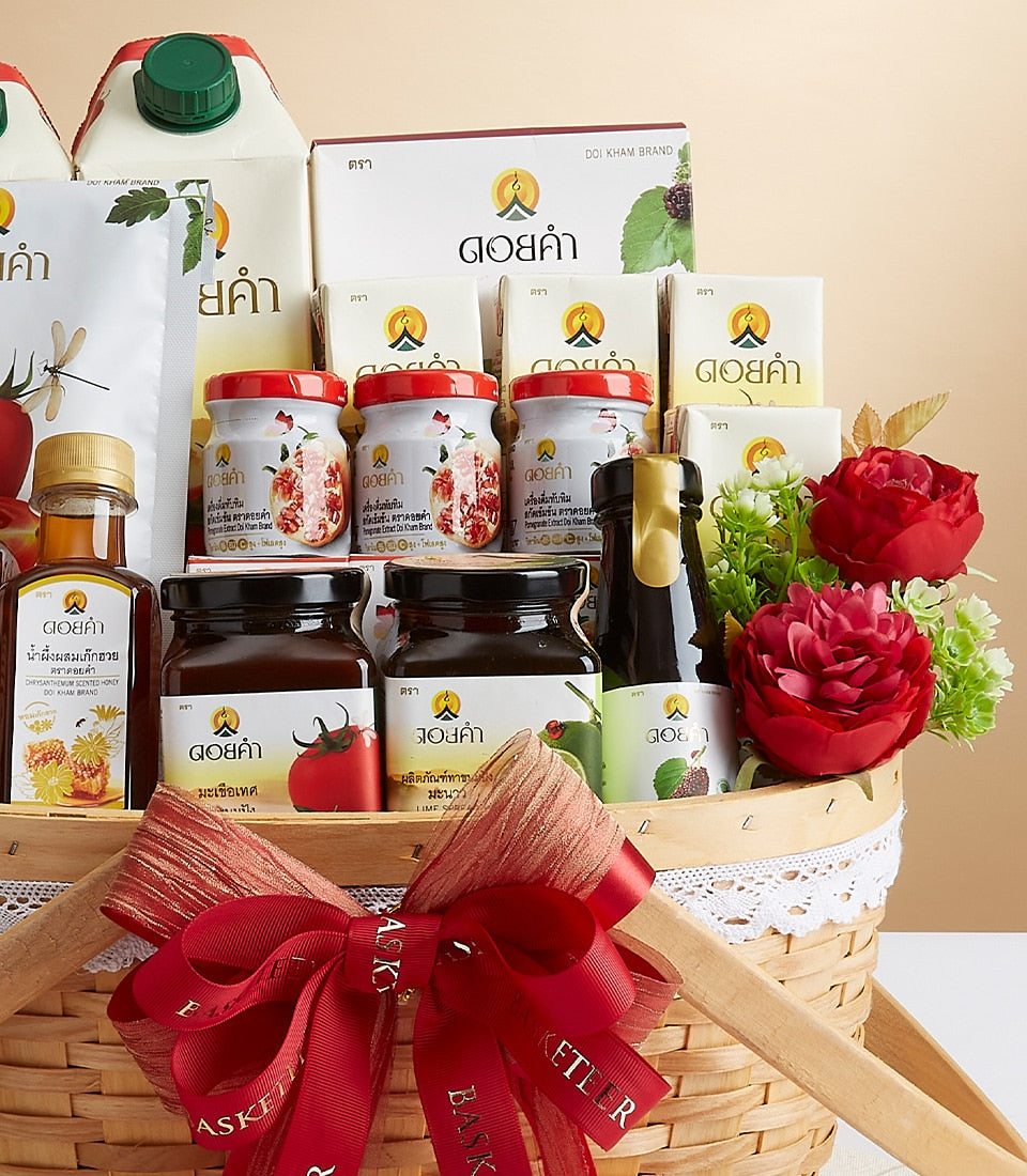 Woven gift basket filled with Doi Kham premium jams, honey, and wellness products in white and red packaging with red ribbon