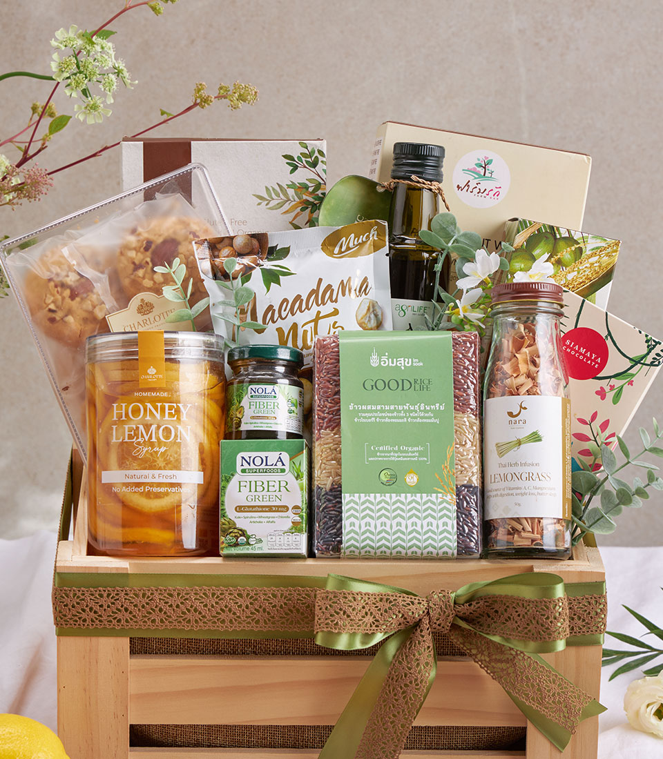 Organic health and wellness gift hamper with pad thai, olive oil, nuts, supplements, and artisan chocolates in wooden crate