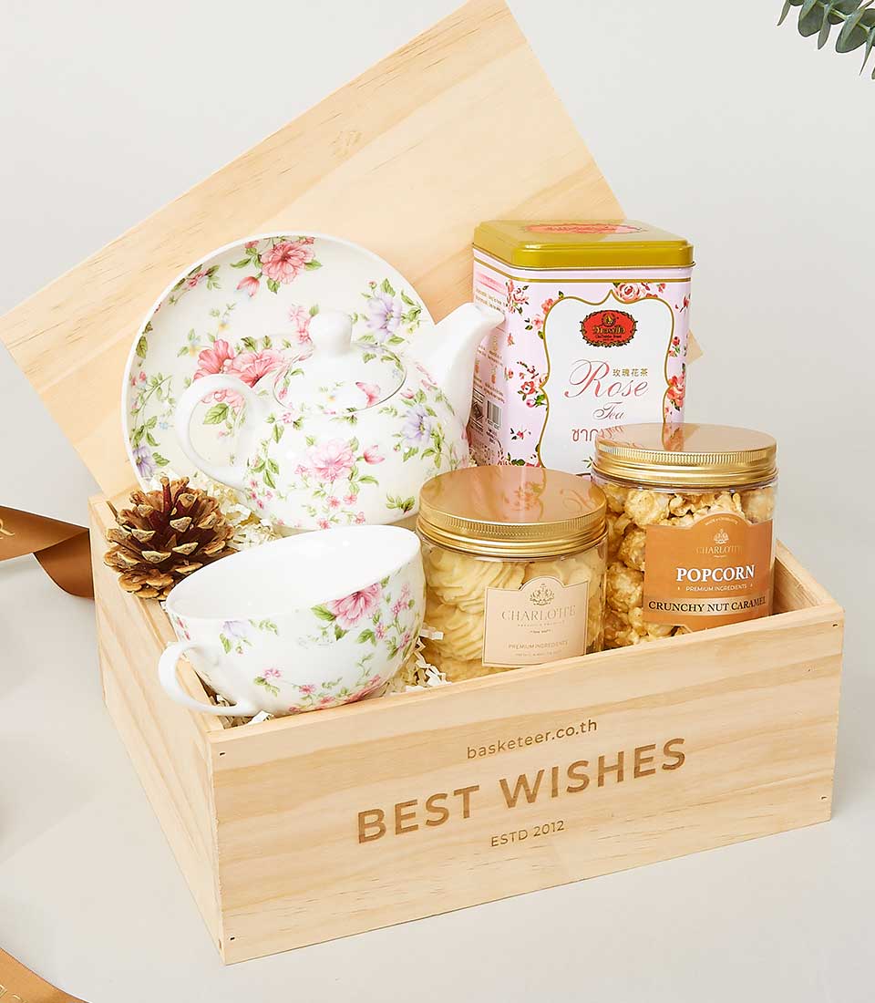 Premium New Year gift basket with floral teapot, rose tea, and gourmet treats in wooden crate