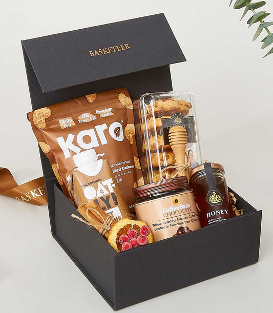 Luxury gourmet gift box with roasted cashews, cookies, honey, and coffee chocolate for New Year