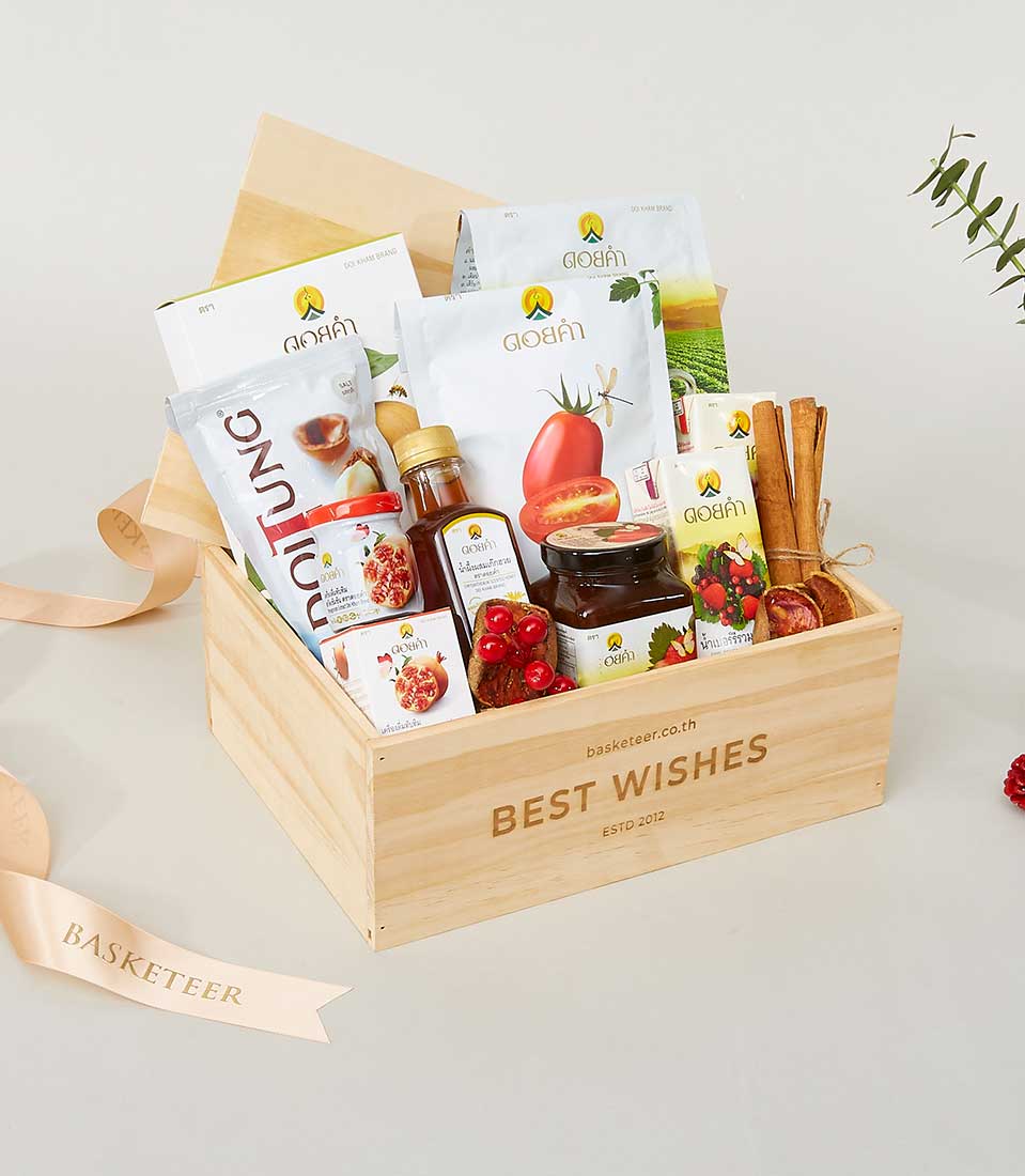 Light wooden gift box with gourmet preserves, Doi Tung nuts, and artisan food selections, tied with peach ribbon