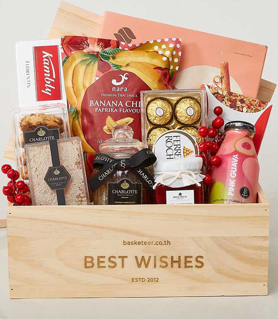 Wooden gourmet gift box with premium snacks, cookies, chocolates, and juices for New Year gifting
