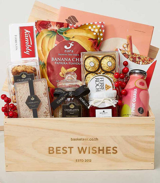 Wooden gourmet gift box with premium snacks, cookies, chocolates, and juices for New Year gifting