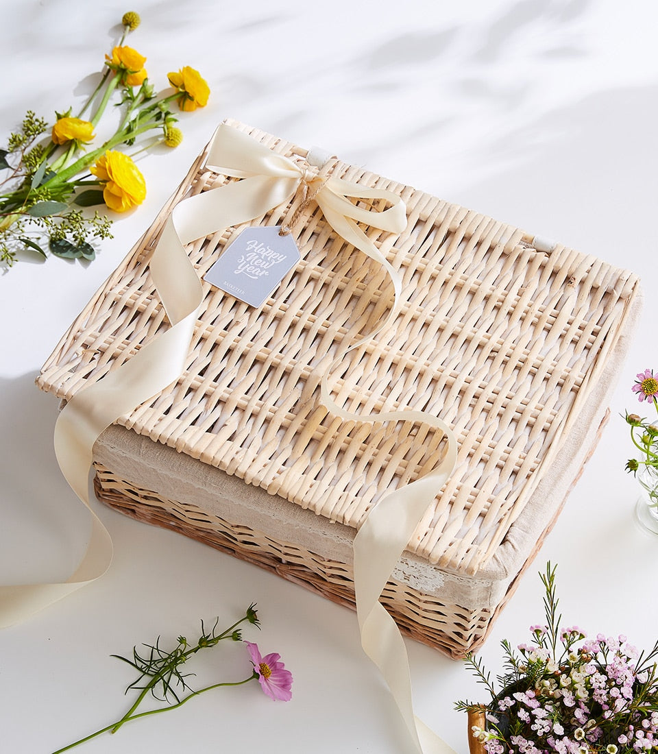 Premium wicker tea hamper with cream satin ribbon and floral arrangement, New Year gift presentation