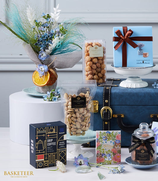 Luxurious gift hamper with blue and white florals, gourmet nuts, chocolates, specialty coffee, and blue gift box
