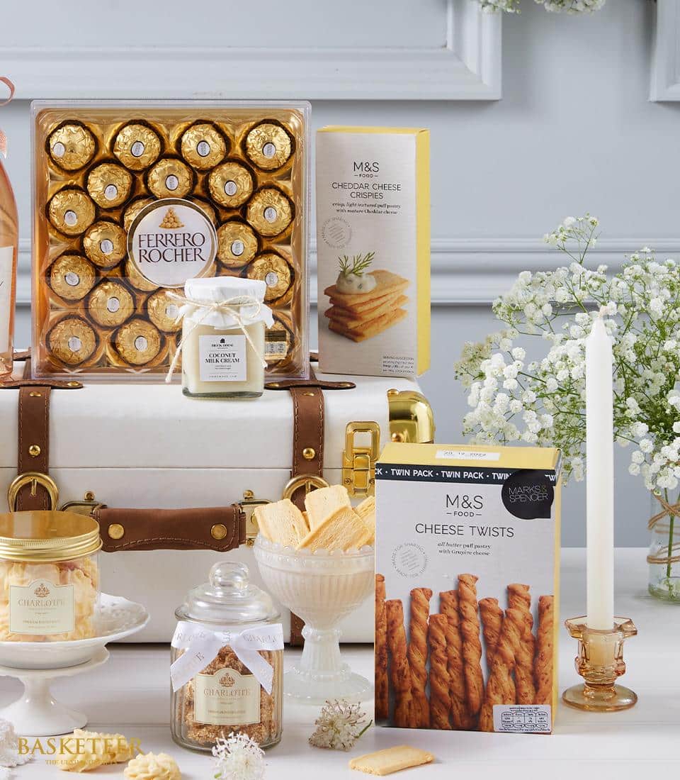 Premium gourmet hamper with Ferrero Rocher chocolates, M&S savory snacks, Charlotte biscuits, and coconut cream in elegant