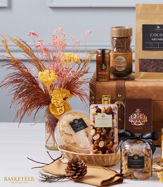Luxury gourmet hamper with dried flowers, honey, coffee, granola, nuts, and artisan chocolates
