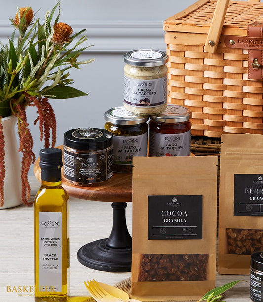 Luxury imported truffle delicacies hamper with artisan granola, olive oil, and gourmet spreads in wicker basket