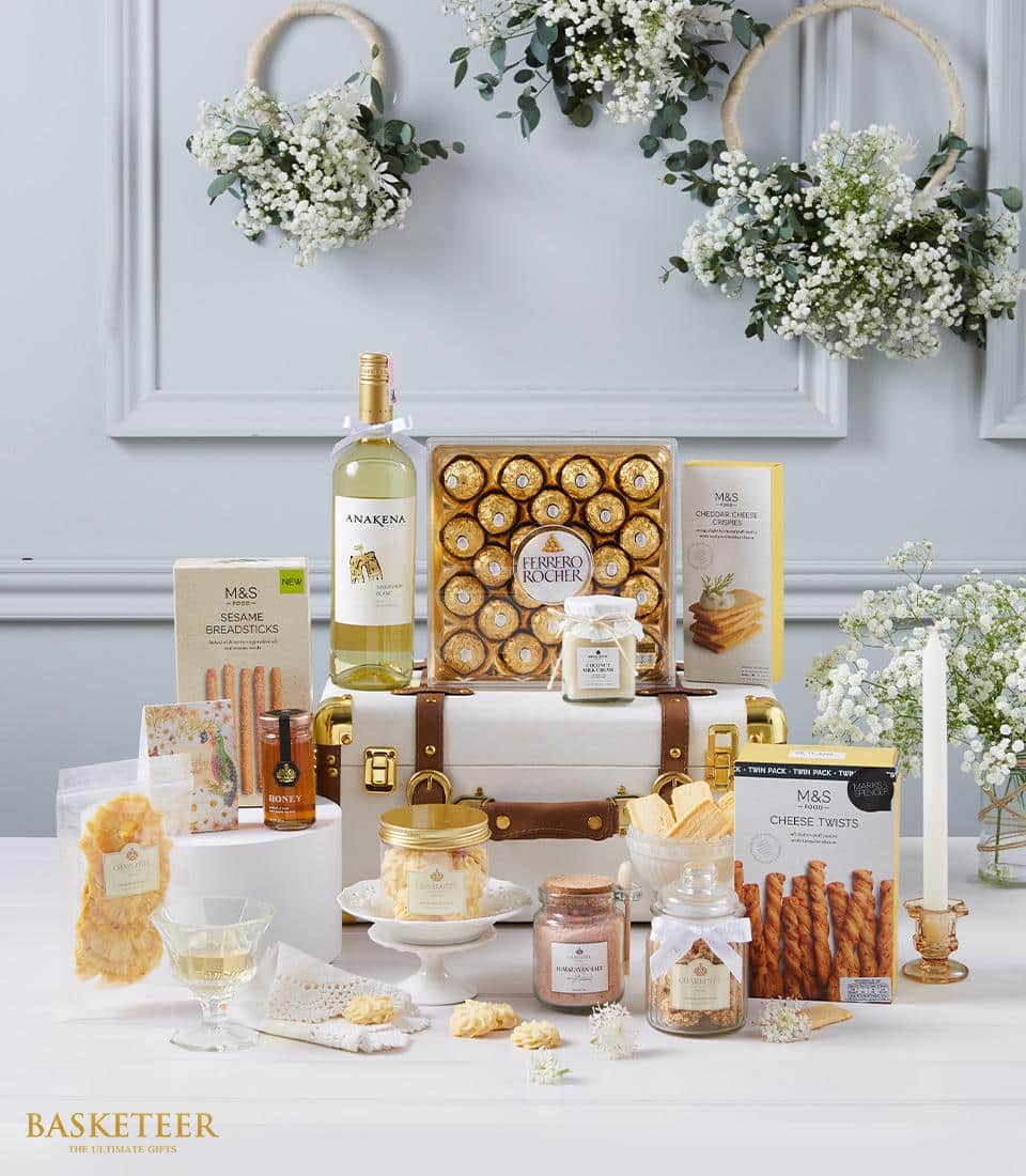 Premium white wine hamper with Ferrero Rocher chocolates, gourmet snacks, and artisan treats in elegant leather trunk