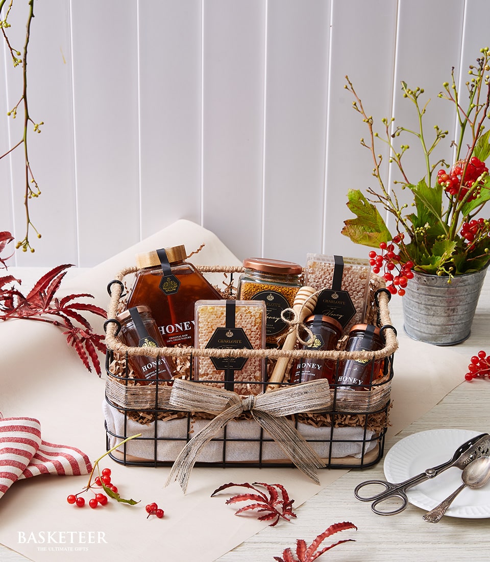 Basketeer premium hamper delivery Thailand. Woven wire gift basket with honey, honeycomb and bee pollen. Perfect corporate gift Bangkok.