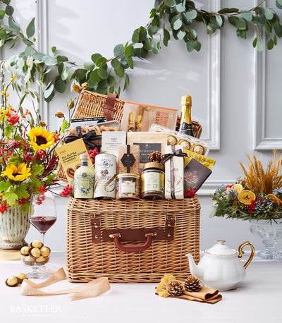 Two-tiered luxury wicker hamper with gourmet chocolates, preserves, wines, and artisan treats for premium gifting