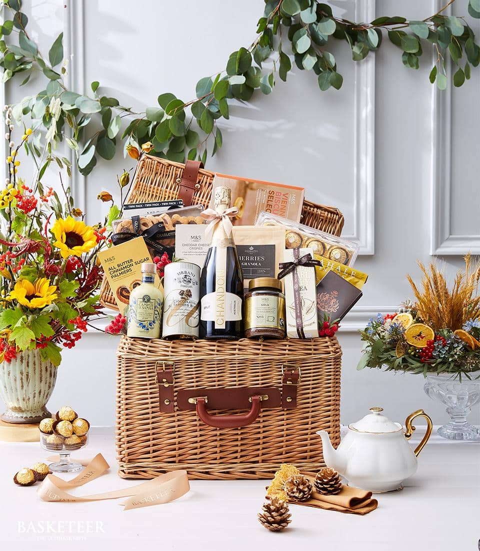 Wicker luxury hamper with champagne, gourmet biscuits, chocolates, and premium spirits for gifting