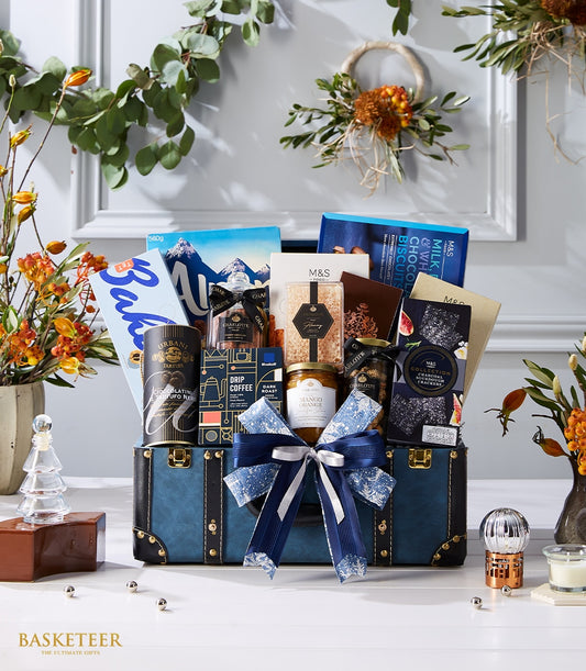Luxury blue and black faux leather trunk hamper filled with gourmet chocolates, preserves, crackers, and premium imported