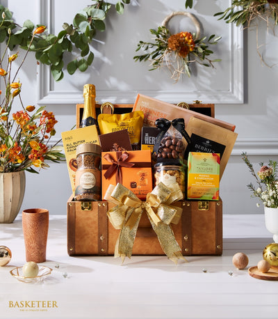Luxury leather-look trunk hamper filled with champagne, chocolates, coffee, biscuits and gourmet treats, tied with gold