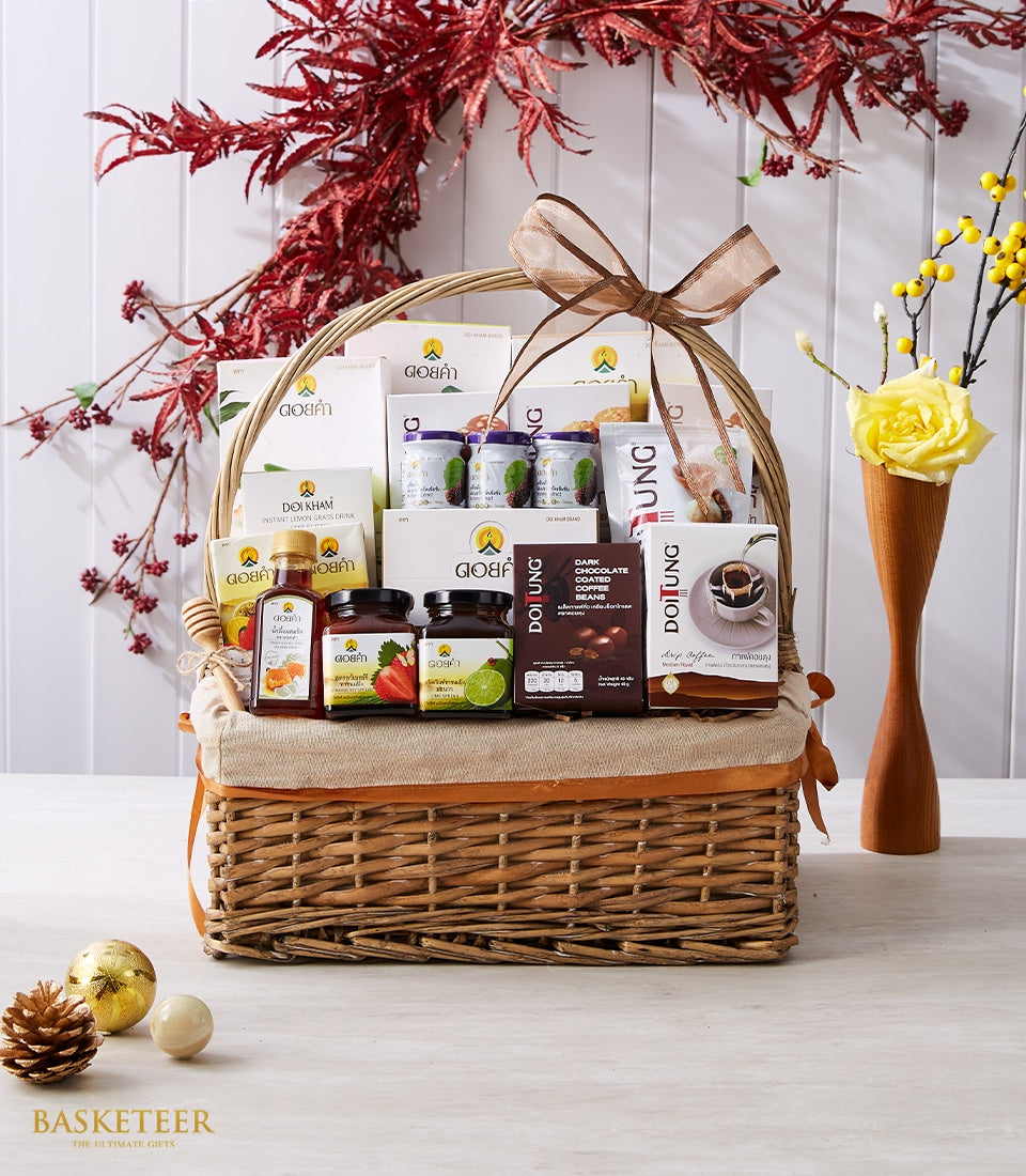 Woven wicker gift basket filled with Doi Tung and Doi Kham gourmet treats, honey, preserves, and specialty coffees with