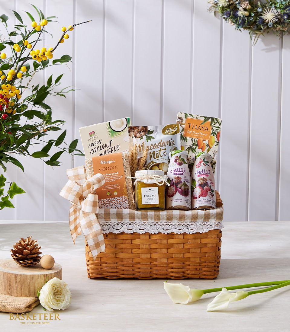 Woven wicker gift basket with Thai gourmet delicacies, coconut waffle, macadamia nuts, dried mango, pineapple jam, and fruit