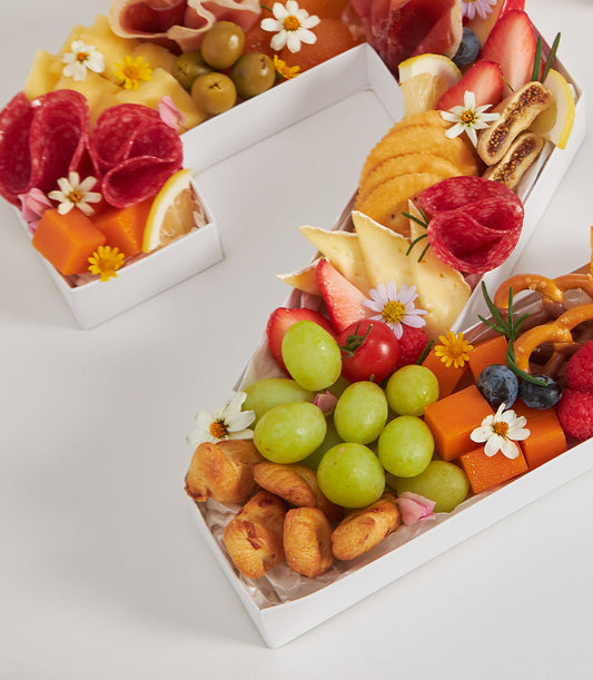 Number-shaped cheese and charcuterie box with fresh fruits, cured meats, and artisan crackers for birthday celebrations