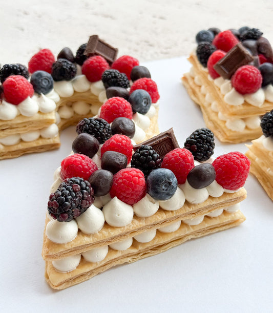 Personalised number cake with chocolate, raspberries, blackberries, and blueberries layered pastry