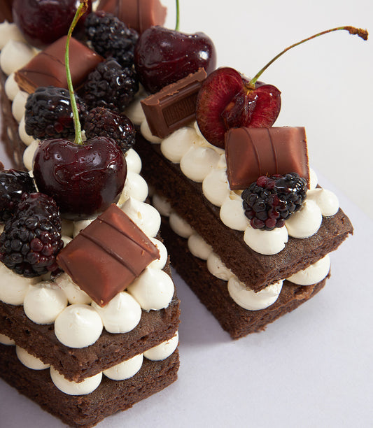 Chocolate cherry bliss letter cake with cream frosting, fresh cherries and blackberries, artisan Charlotte Bakery birthday