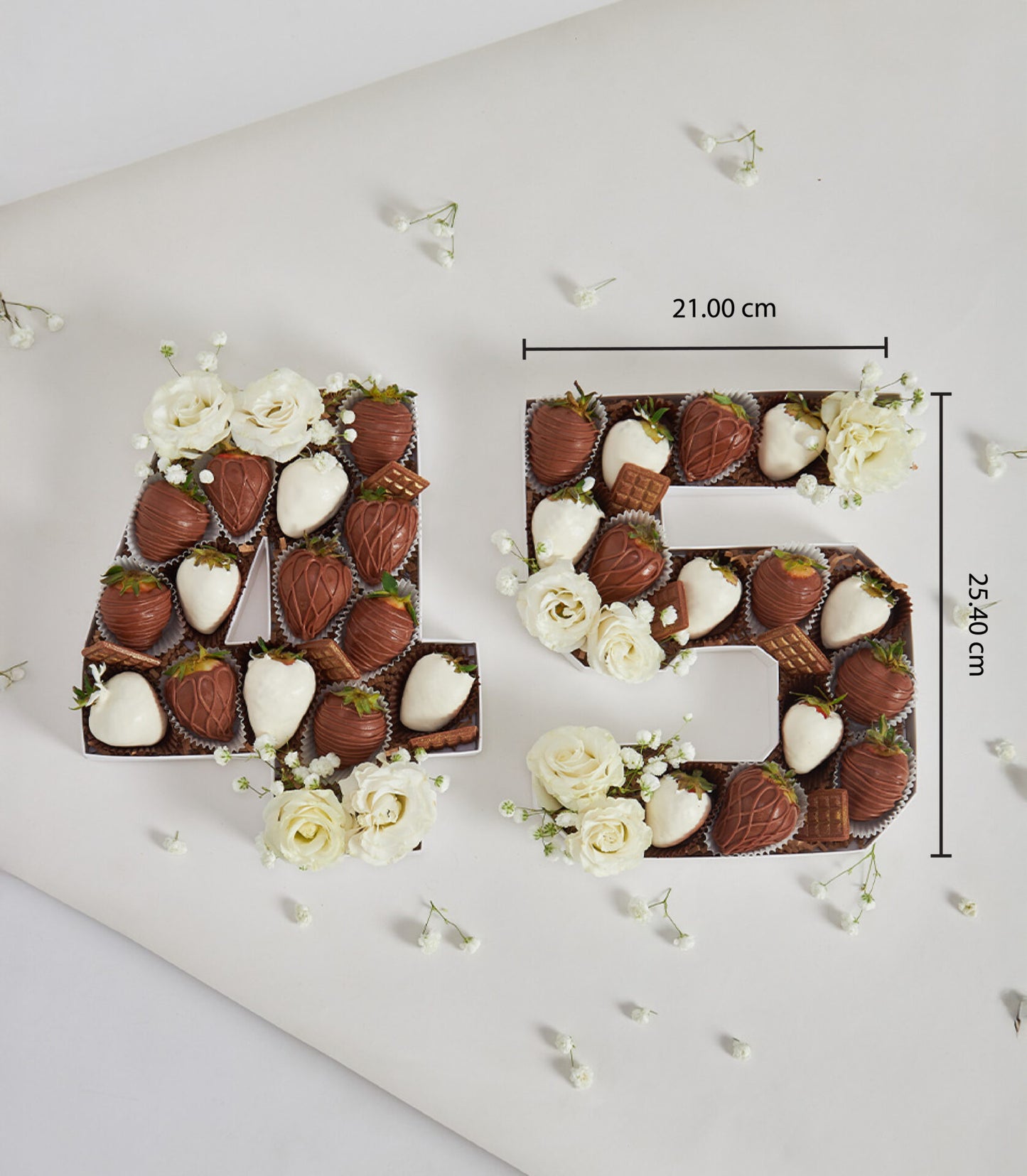 Chocolate-dipped strawberry number cake boxes with white roses for birthday celebrations