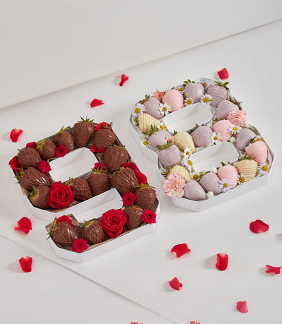 Letter-shaped gift boxes filled with chocolate-dipped strawberries and fresh flowers for celebrations