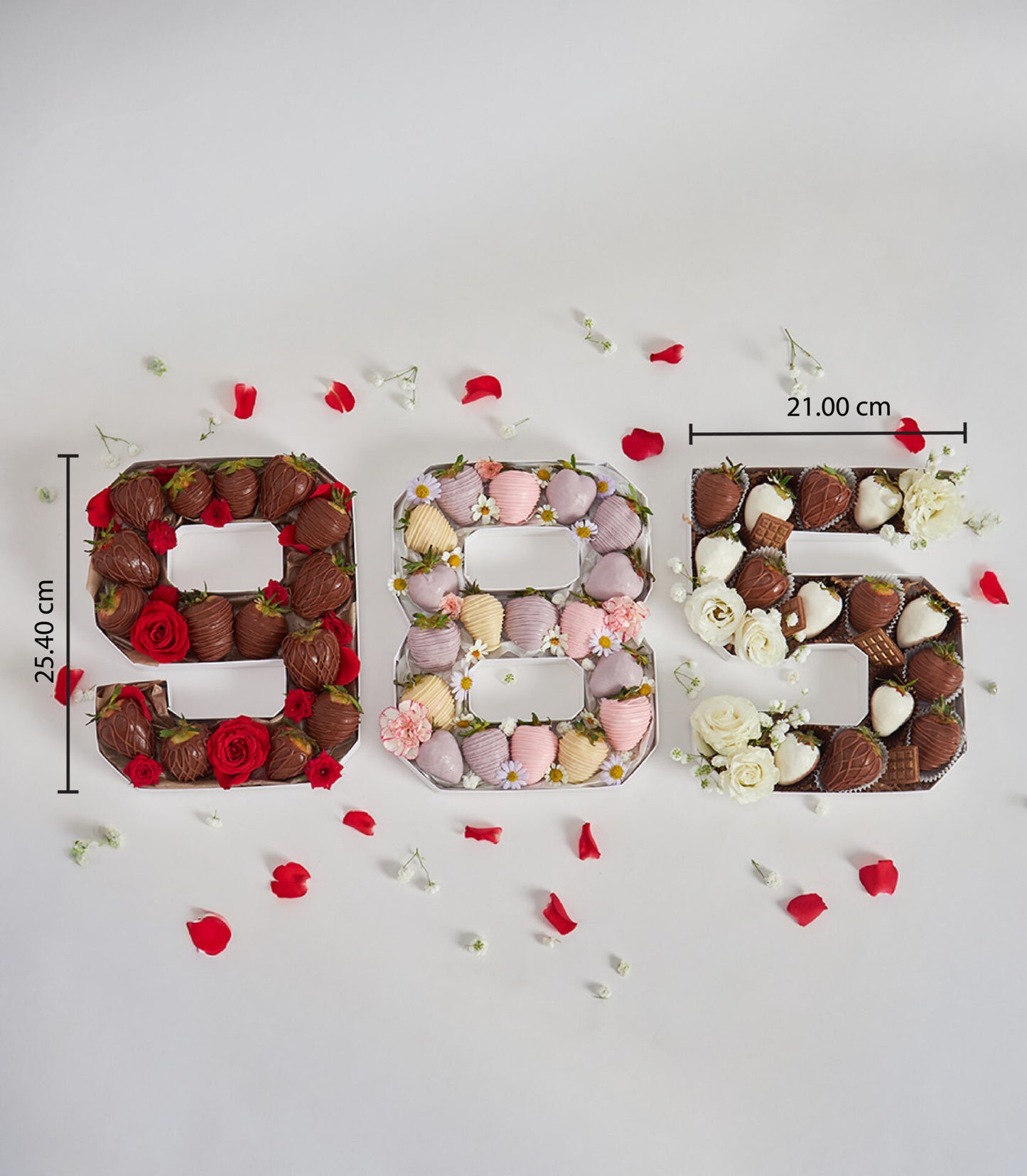 Number-shaped birthday boxes filled with chocolate-covered strawberries and fresh flowers