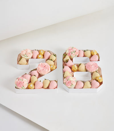 Romantic number boxes filled with chocolate-covered strawberries, Ferrero Rocher, and floral cupcakes for birthday
