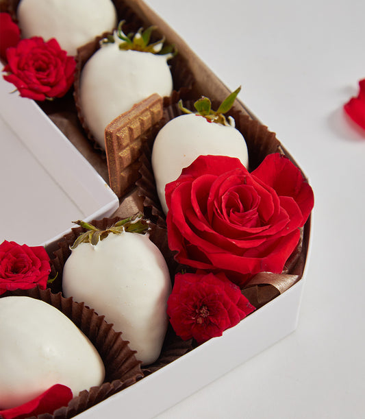 Heart-shaped luxury gift box with white chocolate strawberries, red roses, and milk chocolate piece